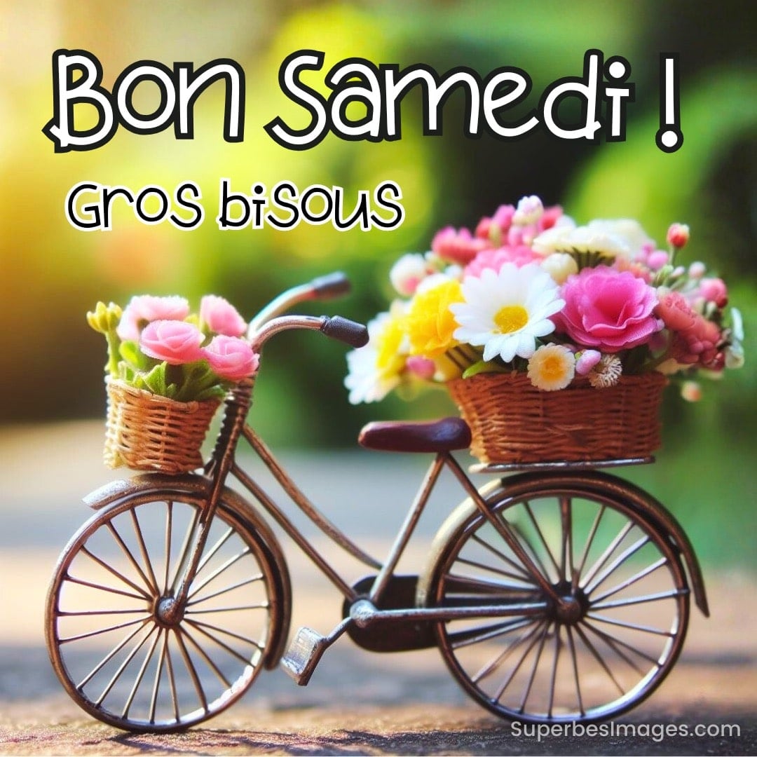 Vélo décoratif avec paniers fleuris et texte « Bon Samedi ! Gros bisous » sur fond vert flou